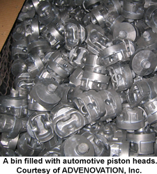 A bin filled with automotive piston heads. Courtesy of ADVENOVATION, Inc.