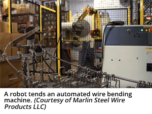 A robot tends an automated wire bending machine. (Courtesy of Marlin Steel Wire Products LLC)